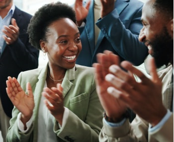 corporate event guests clap during a presentation