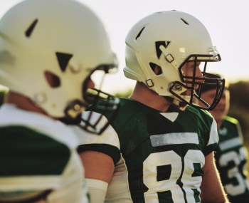 football players regroup before a play